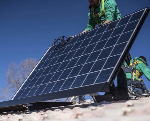 Solar panel technician mounting the solar panel