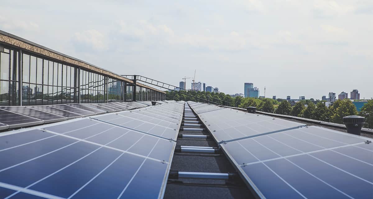 solar panels on the industrial rooftop showing the city on the horizon