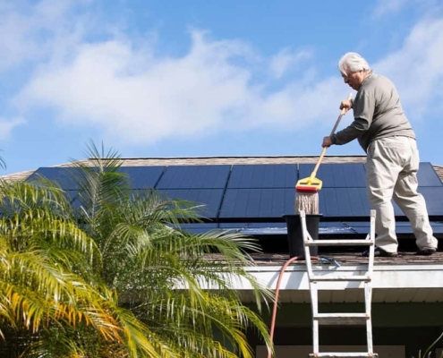 Jerry Buechler, of Port St. Lucie, Florida, cleans the 28 solar panels on his roof .