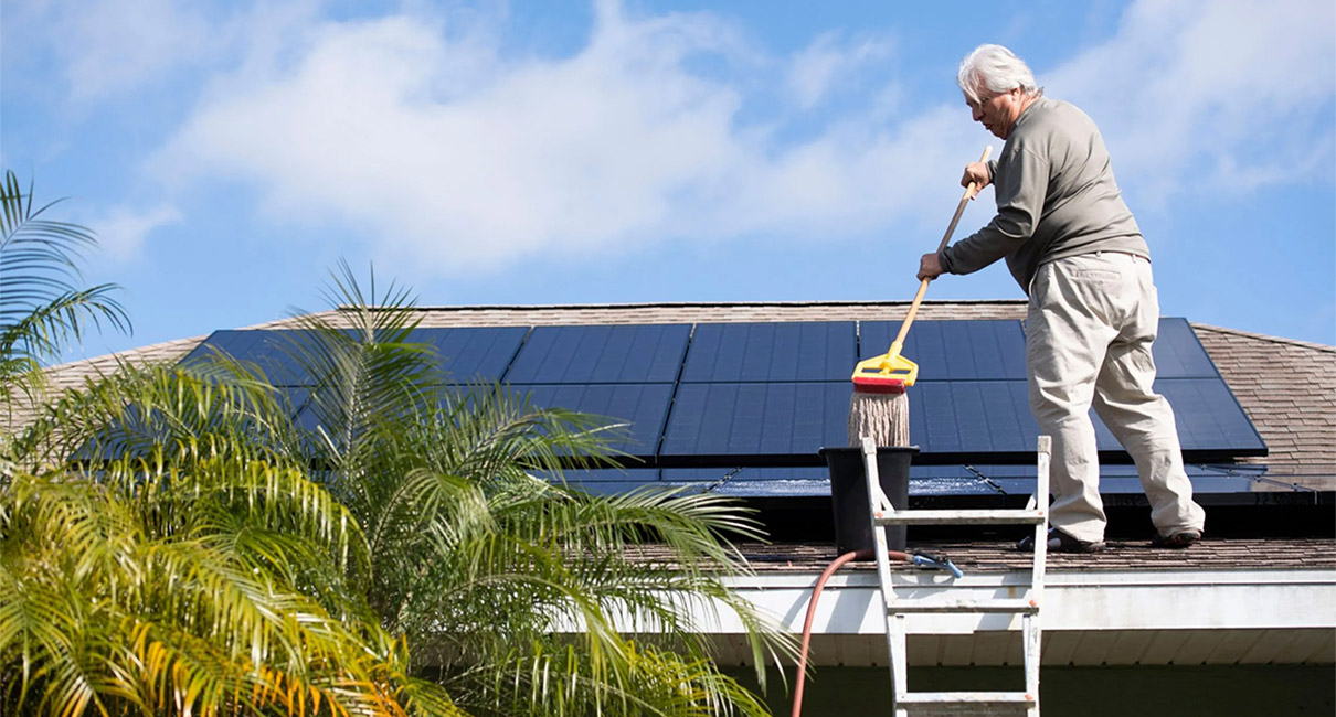 Jerry Buechler, of Port St. Lucie, Florida, cleans the 28 solar panels on his roof .