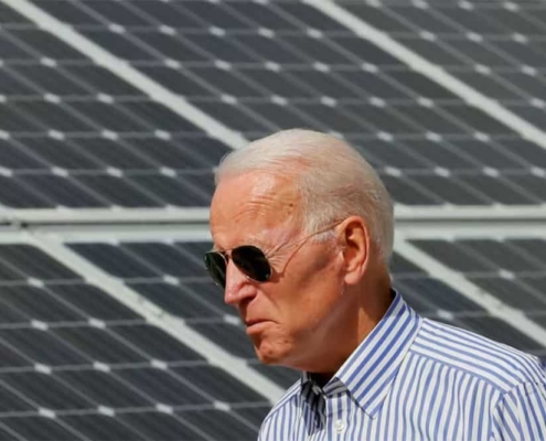 Joe biden with solar panels on the background