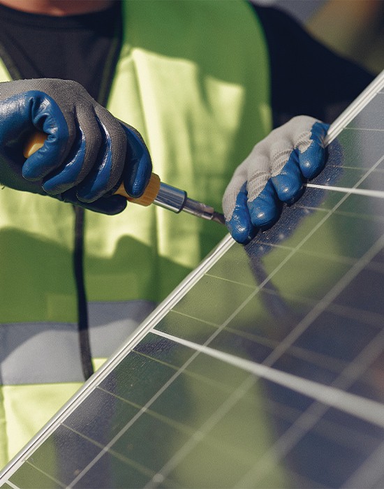 worker finishing the solar panel installation