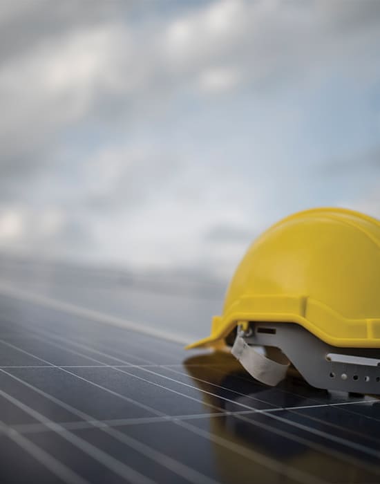 yellow helmet on top of the solar panel
