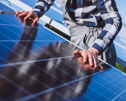 man with his hands on a solar panel