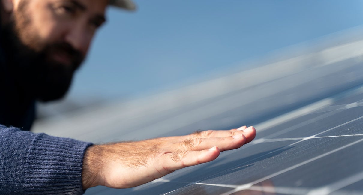 person checking solar panels