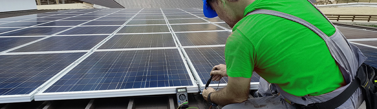 man doing maintenance on solar panels