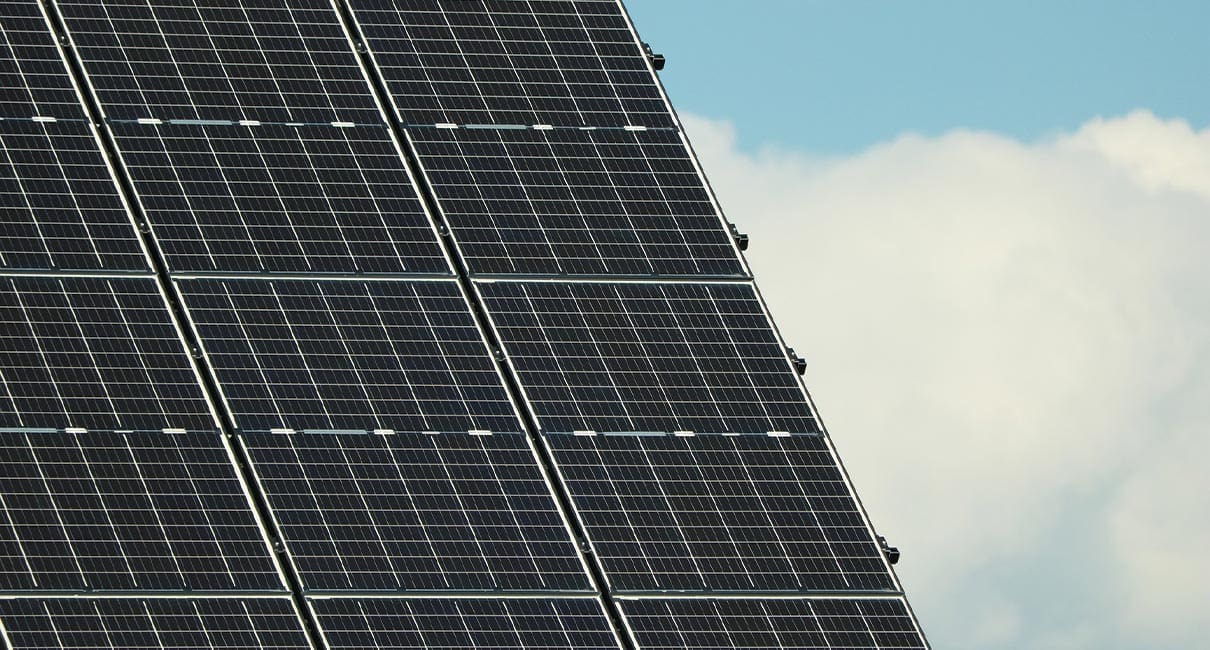 solar panels with a cloud on the background